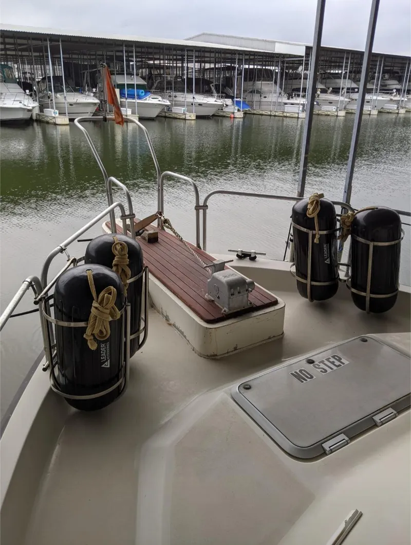 Slide: The Image of 1989 Mainship 41 Grand Salon yacht deck with docked boats in the background. - 11