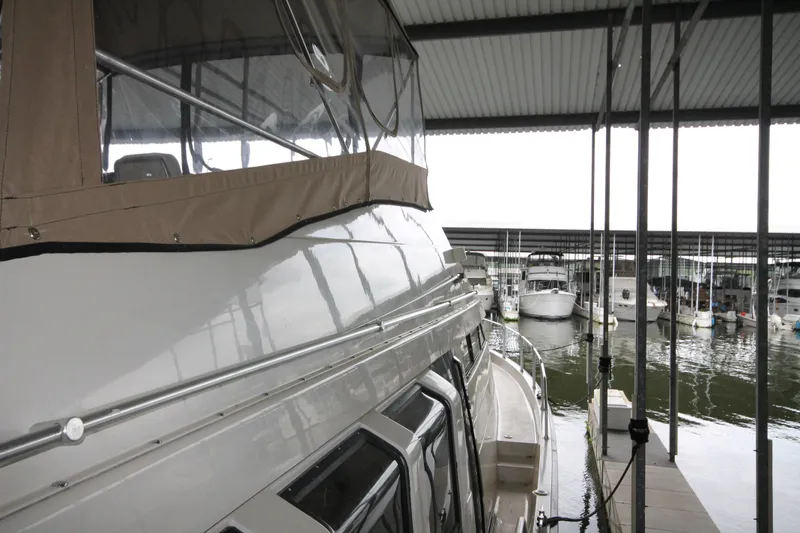 Slide: The Image of 1989 Mainship 41 Grand Salon yacht docked in a covered marina. - 16