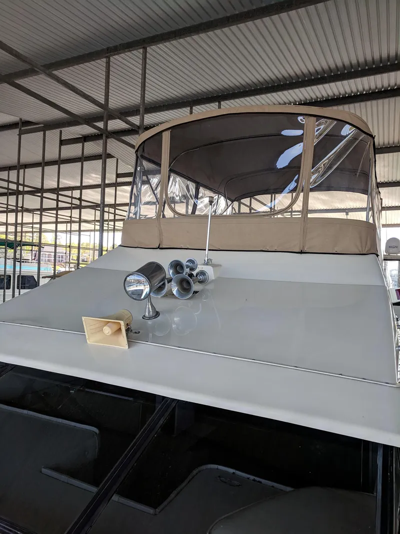 Slide: The Image of 1989 Mainship 41 Grand Salon yacht with covered flybridge in marina. - 19