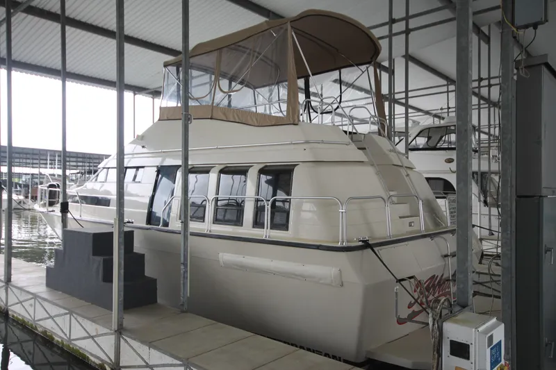 Slide: The Image of 1989 Mainship 41 Grand Salon yacht docked in a covered marina. - 2
