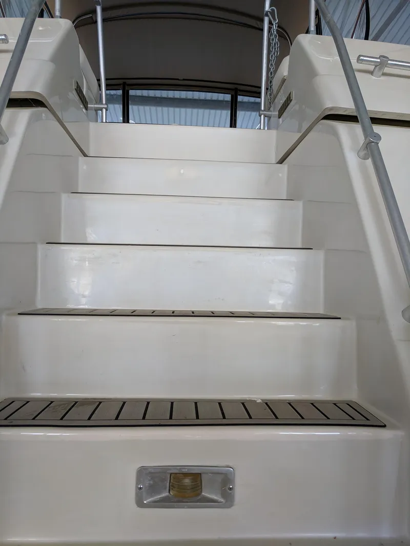 Slide: The Image of Staircase on 1989 Mainship 41 Grand Salon yacht, featuring sleek white design. - 20