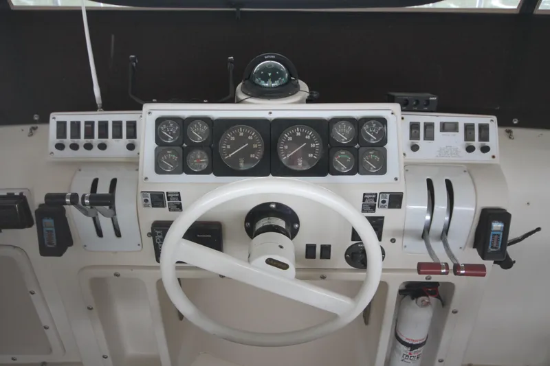Slide: The Image of 1989 Mainship 41 Grand Salon helm with steering wheel and instrument panel. - 31