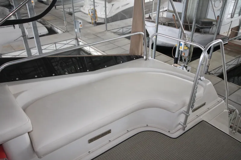 Slide: The Image of 1989 Mainship 41 Grand Salon boat seating area in a marina setting. - 34