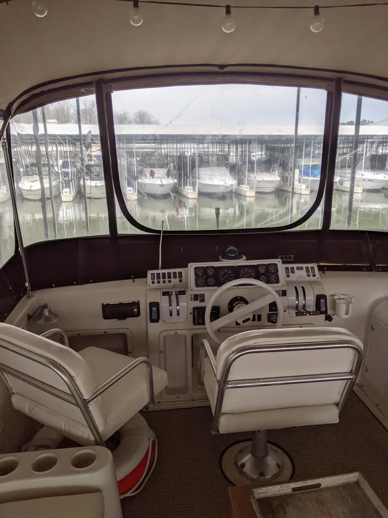 Slide: The Image of 1989 Mainship 41 Grand Salon helm with marina view through large windows. - 37
