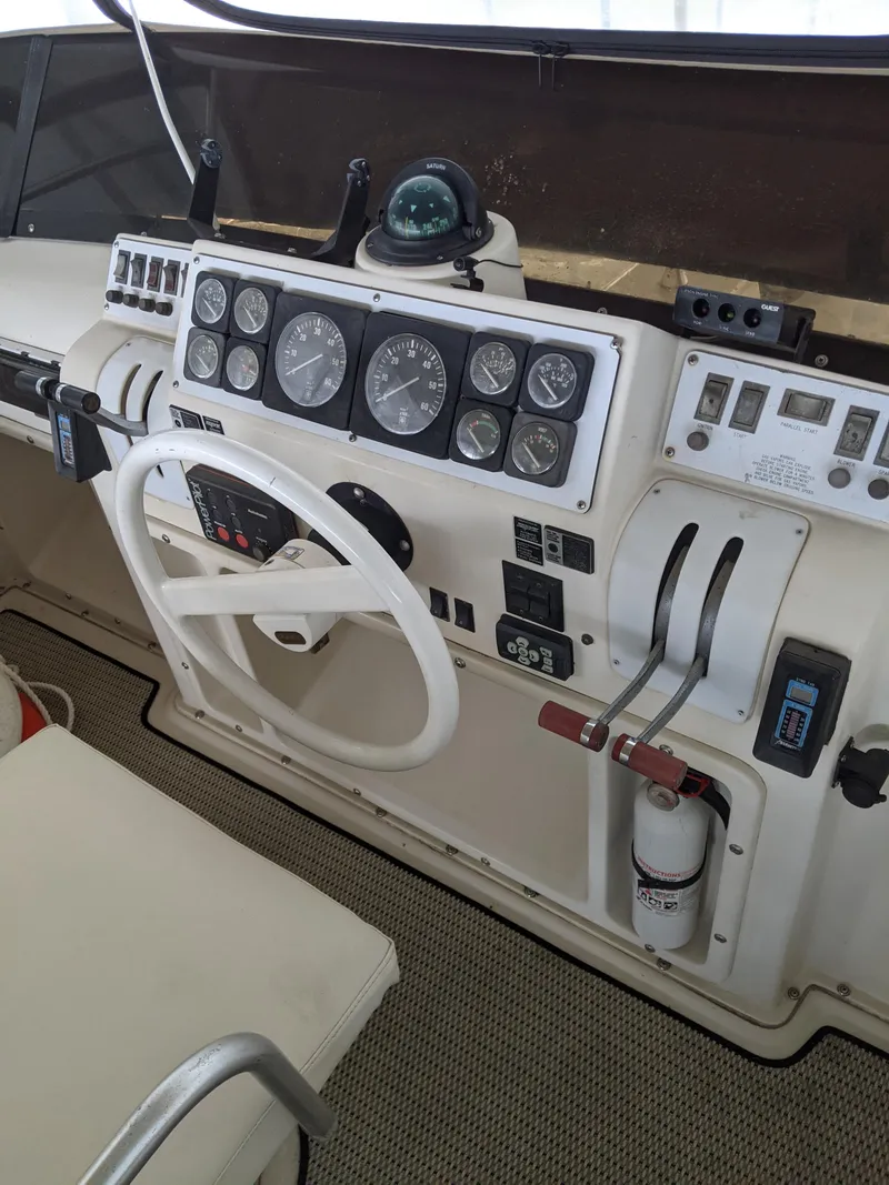Slide: The Image of 1989 Mainship 41 Grand Salon helm with gauges, steering wheel, and controls. - 38