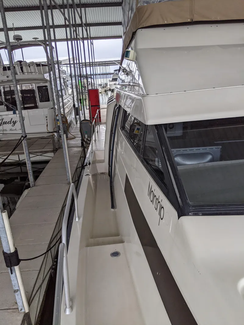 Slide: The Image of 1989 Mainship 41 Grand Salon yacht docked in a marina. - 39