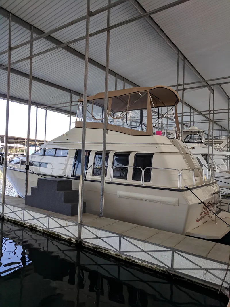Slide: The Image of 1989 Mainship 41 Grand Salon yacht docked in a covered marina. - 4