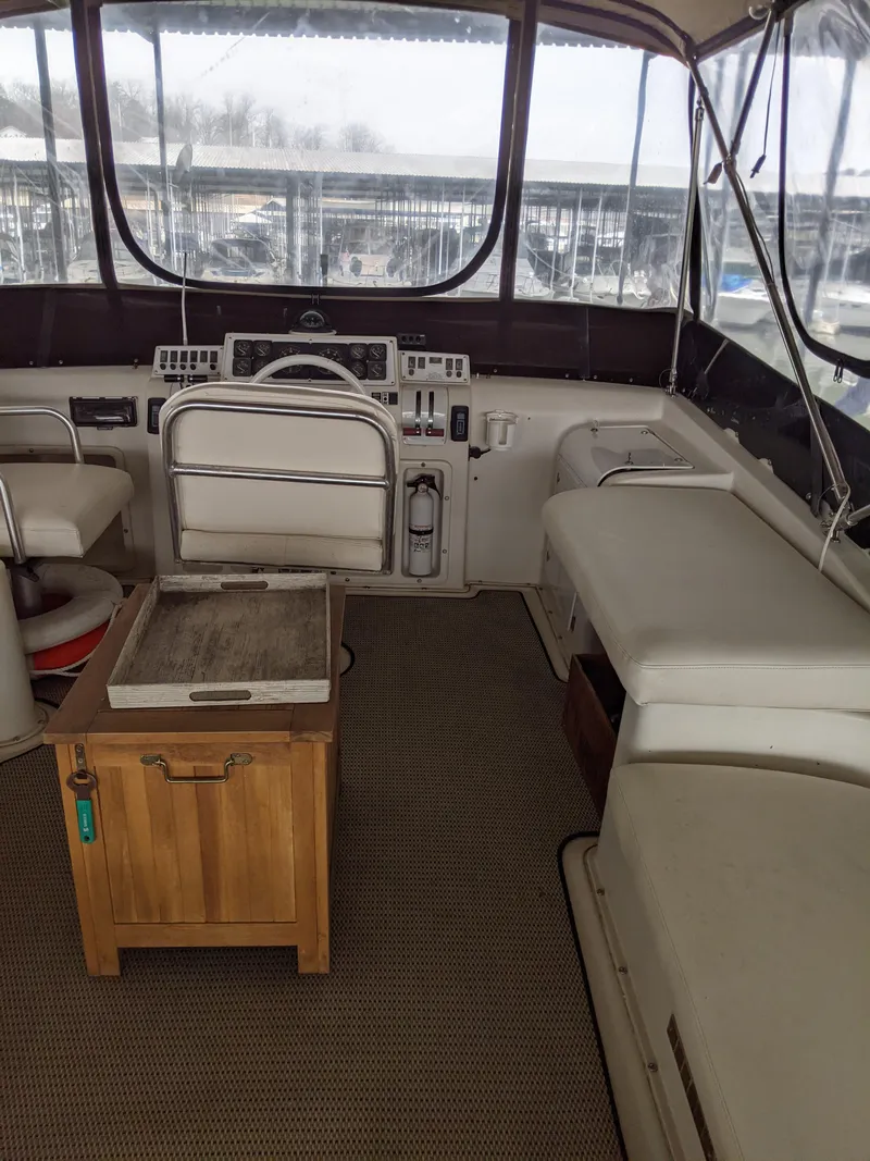 Slide: The Image of 1989 Mainship 41 Grand Salon interior with helm, seating, and wooden table. - 41