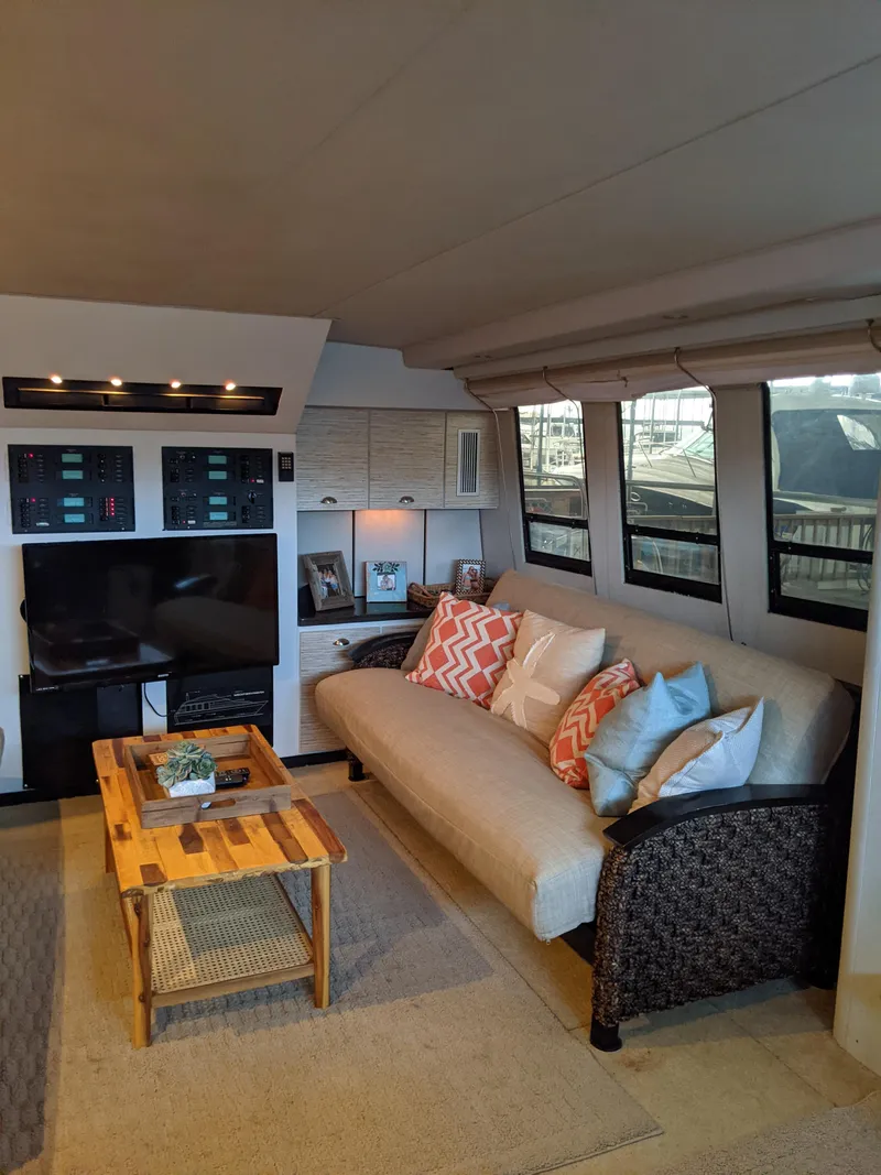 Slide: The Image of 1989 Mainship 41 Grand Salon interior with cozy seating and modern decor. - 44