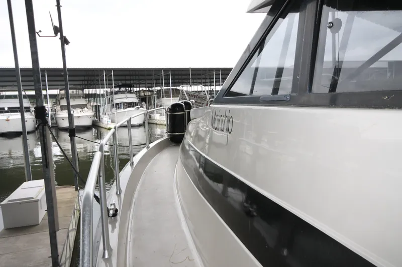 Slide: The Image of 1989 Mainship 41 Grand Salon yacht docked at marina, side view. - 6