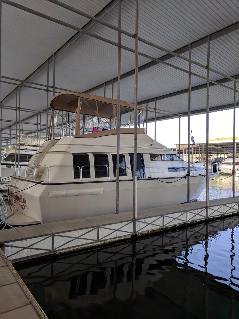 Slide: The Image of 1989 Mainship 41 Grand Salon yacht docked in a covered marina. - 7