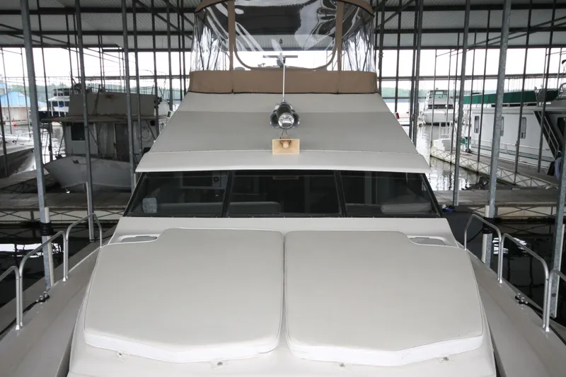 Slide: The Image of 1989 Mainship 41 Grand Salon yacht docked in a covered marina. - 8