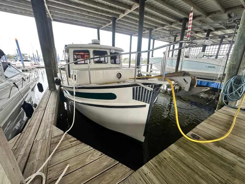 Slide: The Image of Nordic Tug 37, 2001 model, docked in a covered marina slip. - 2