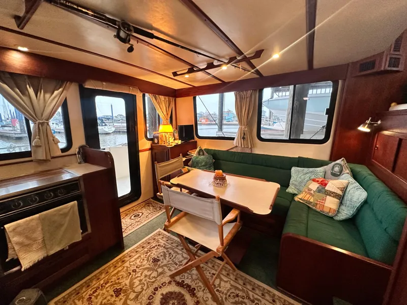 Slide: The Image of Cozy interior of a 2001 Nordic Tug 37 with dining area and windows. - 22
