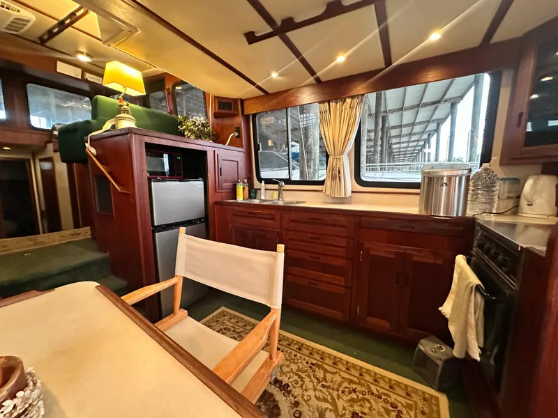 Slide: The Image of Interior of 2001 Nordic Tug 37, featuring a cozy kitchen and dining area. - 26