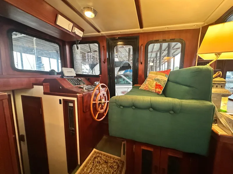 Slide: The Image of Interior of 2001 Nordic Tug 37, featuring helm station and cozy seating area. - 30