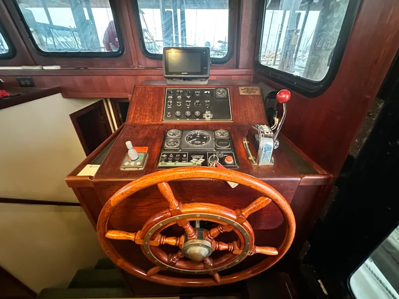 Slide: The Image of Pilothouse of 2001 Nordic Tug 37 with wooden wheel and control panel. - 35