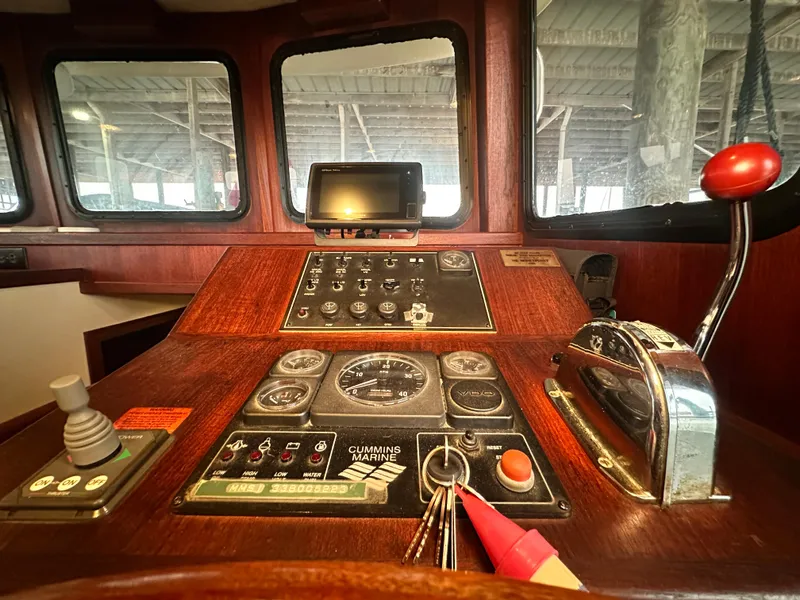 Slide: The Image of Control panel of a 2001 Nordic Tug 37 boat, featuring navigation and engine controls. - 36
