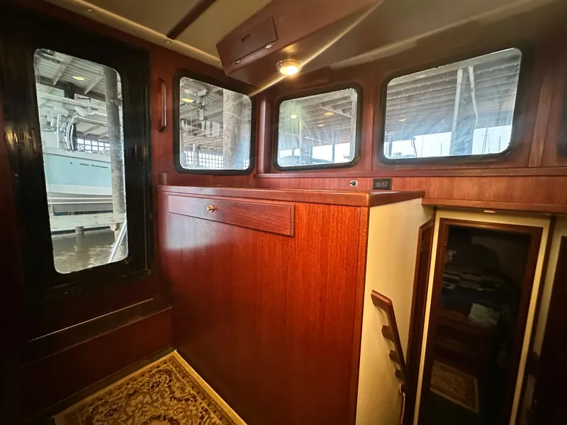 Slide: The Image of Interior of 2001 Nordic Tug 37, featuring wood paneling and windows. - 39