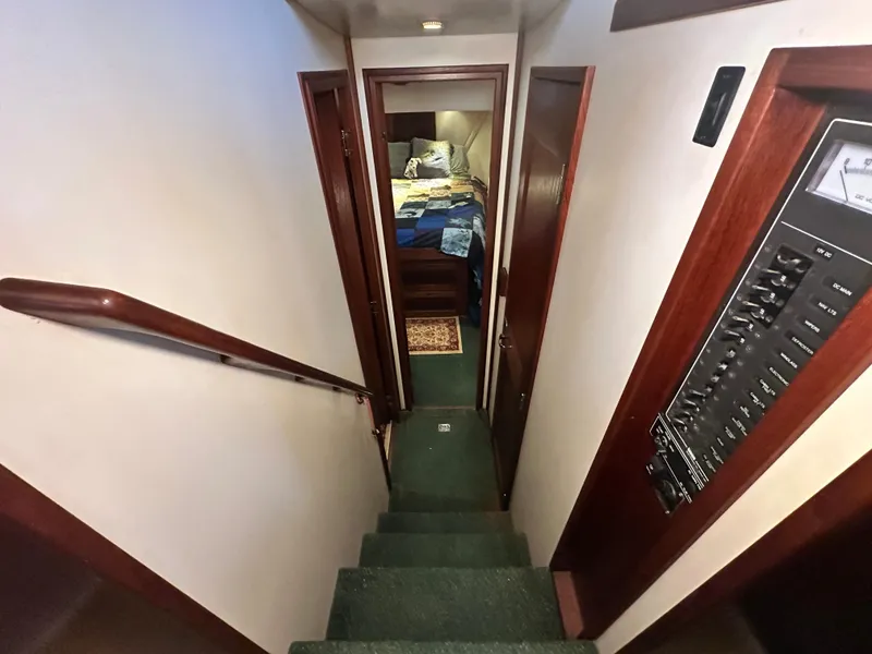 Slide: The Image of Interior of 2001 Nordic Tug 37, showing stairs leading to a cozy bedroom. - 40