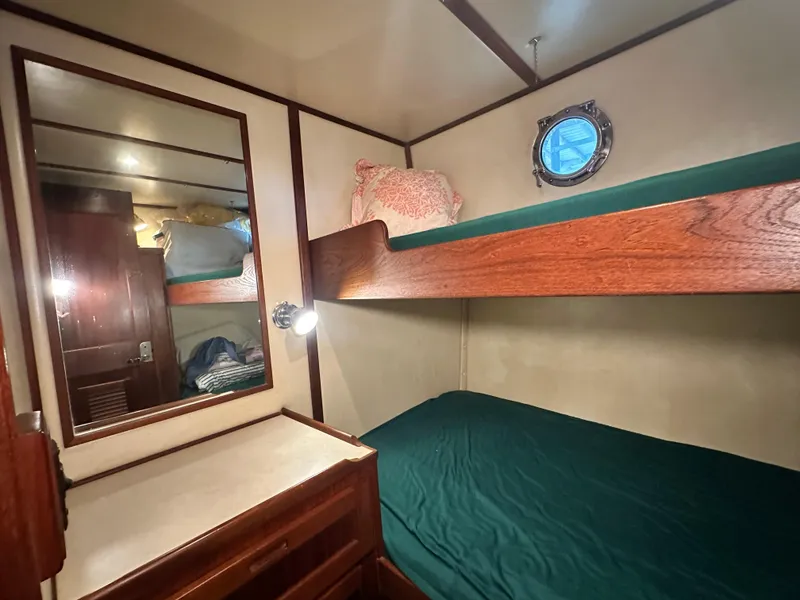 Slide: The Image of Cozy cabin with bunk beds in 2001 Nordic Tug 37 boat interior. - 43