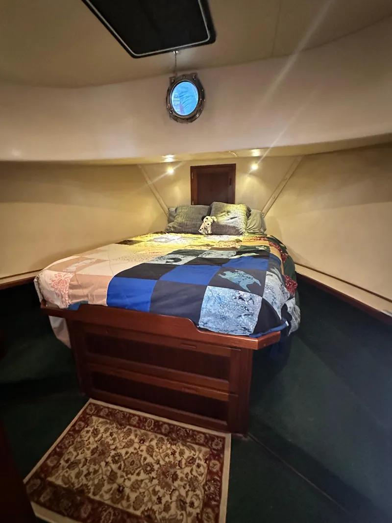 Slide: The Image of Cozy cabin interior of 2001 Nordic Tug 37 with a colorful quilted bedspread. - 47