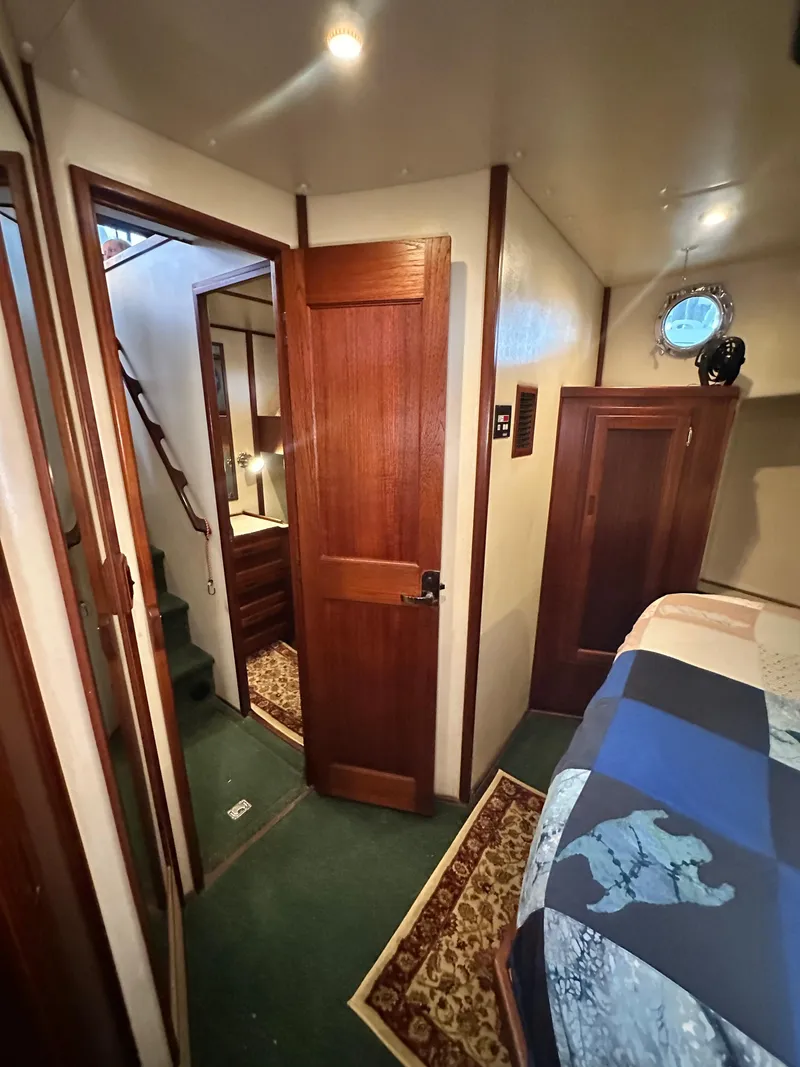 Slide: The Image of Interior of a 2001 Nordic Tug 37, featuring wooden doors and cozy cabin decor. - 51