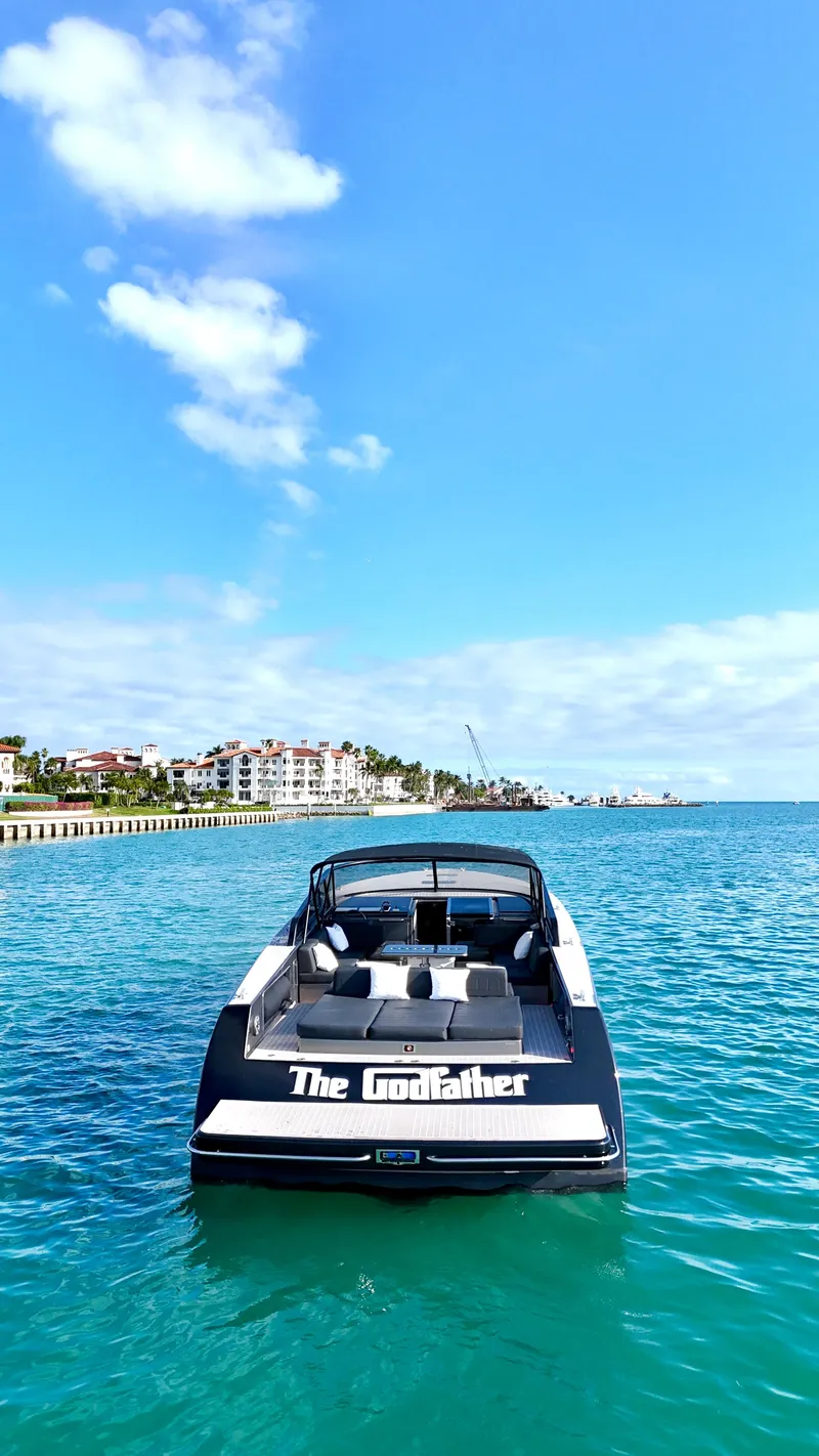 Slide: The Image of VanDutch 55 yacht, 2014 model, named "The Godfather" on clear blue water. - 11