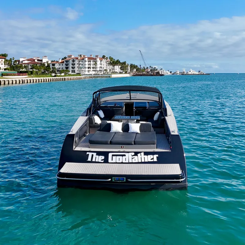 Slide: The Image of VanDutch 55 yacht named "The Godfather" cruising in clear blue waters, 2014 model. - 12