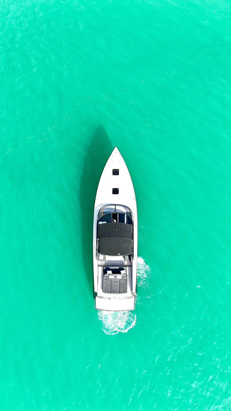 Slide: The Image of Aerial view of 2014 VanDutch 55 yacht cruising on turquoise water. - 13
