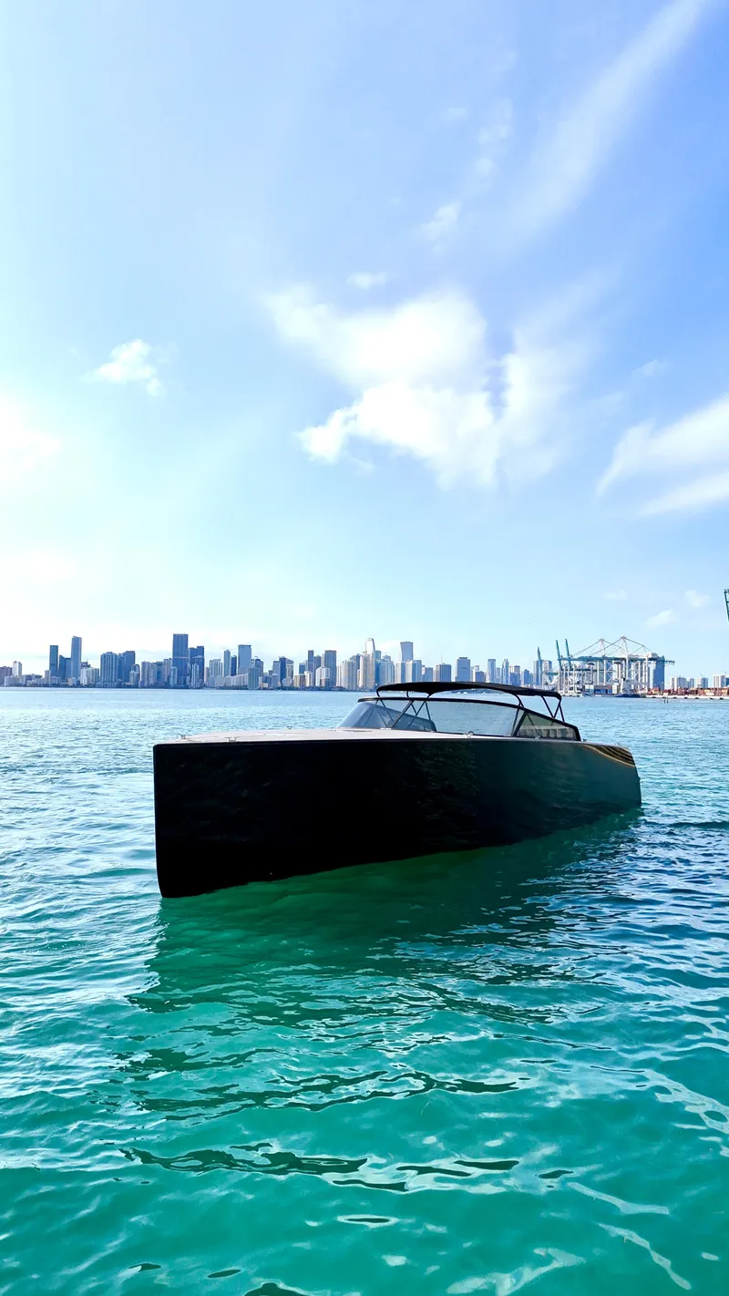 Slide: The Image of 2014 VanDutch 55 yacht on turquoise water with city skyline in the background. - 17