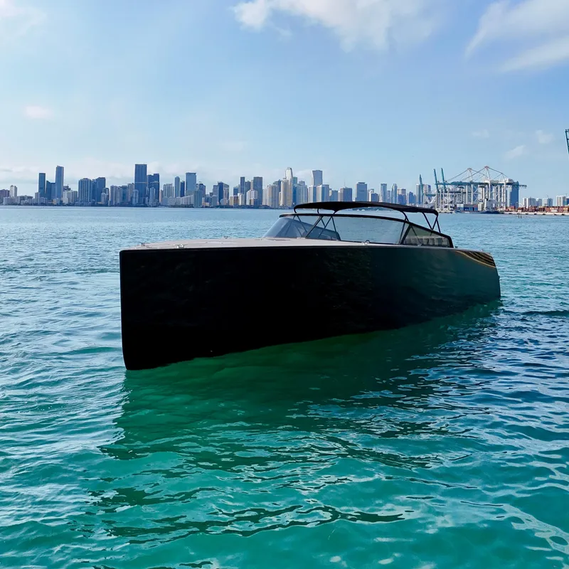 Slide: The Image of VanDutch 55 yacht on turquoise water with city skyline in background, 2014 model. - 18