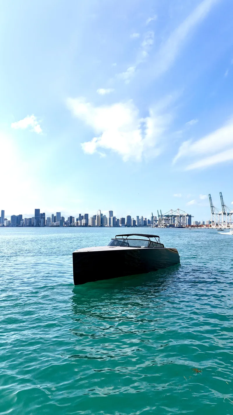Slide: The Image of VanDutch 55 yacht on blue water with city skyline in background, 2014 model. - 19
