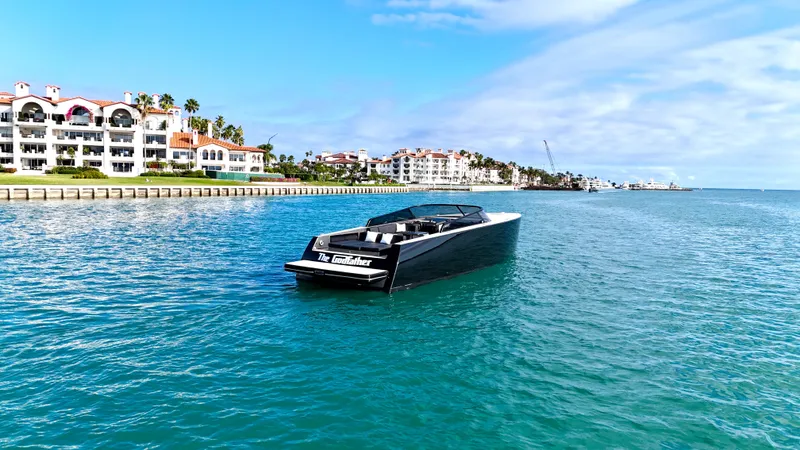 Slide: The Image of 2014 VanDutch 55 yacht cruising near waterfront buildings under a clear blue sky. - 25