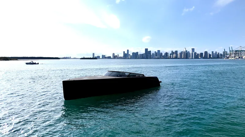Slide: The Image of VanDutch 55 yacht on water with city skyline in background, 2014 model. - 38