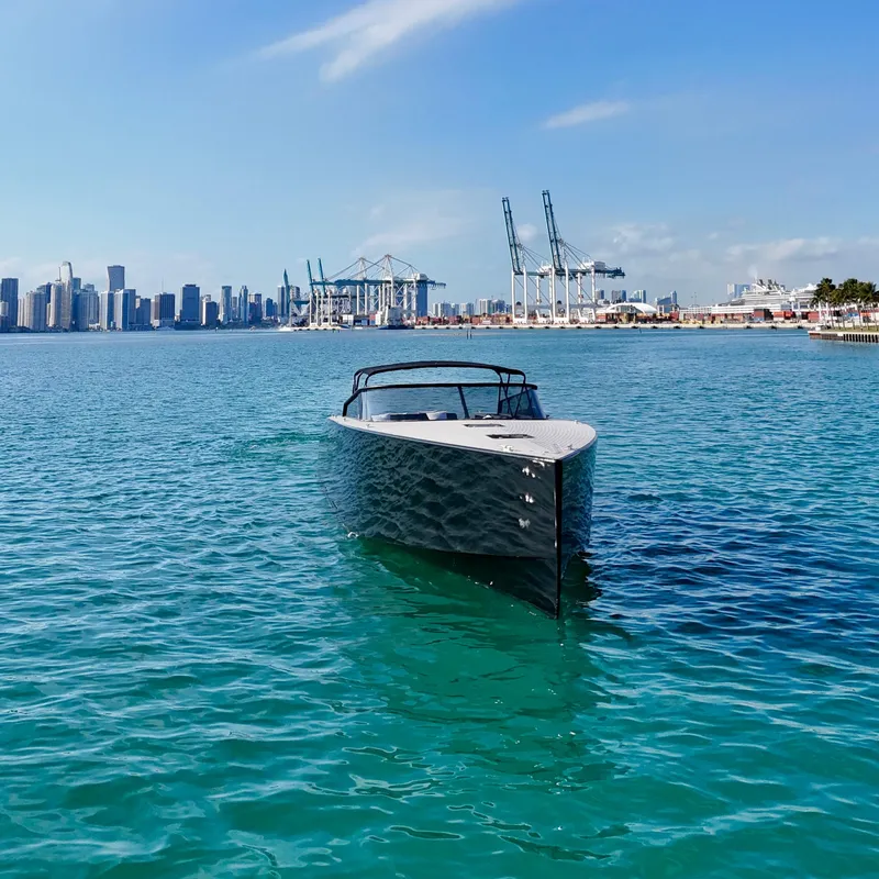 Slide: The Image of VanDutch 55 yacht on clear water with city skyline and cranes in the background. - 5