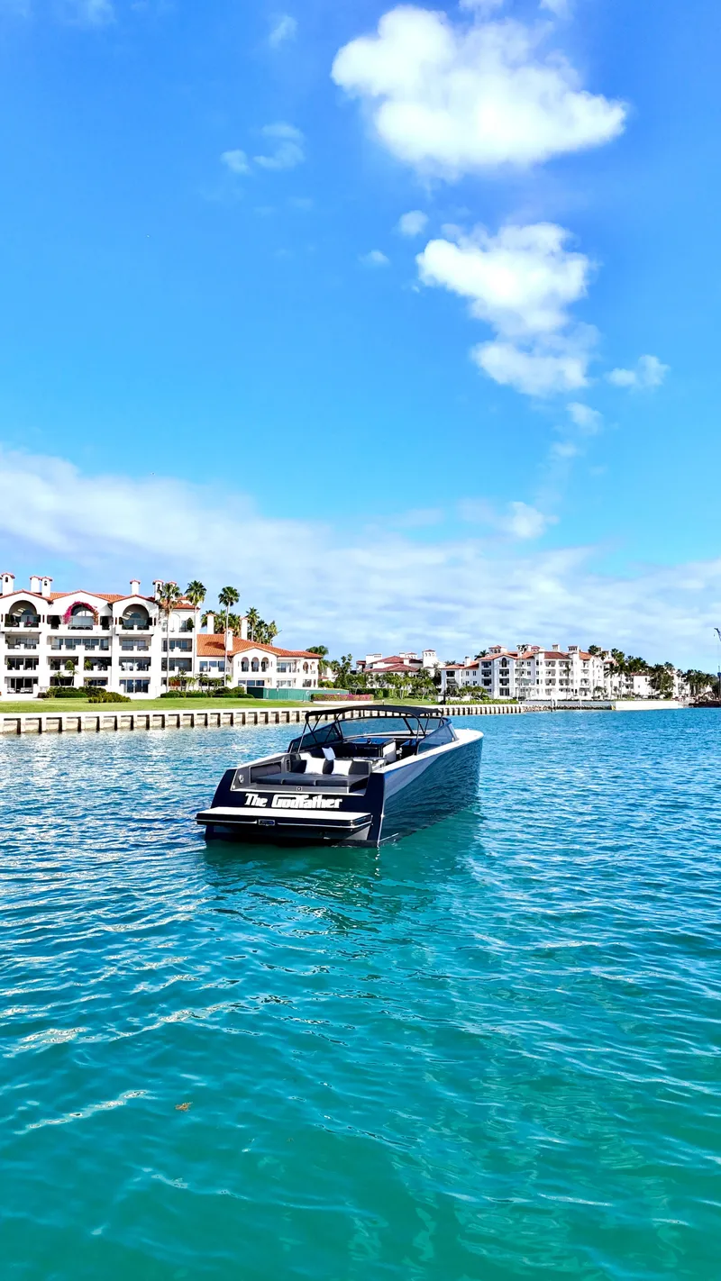 Slide: The Image of Luxurious 2014 VanDutch 55 yacht cruising near waterfront homes under a clear blue sky. - 7