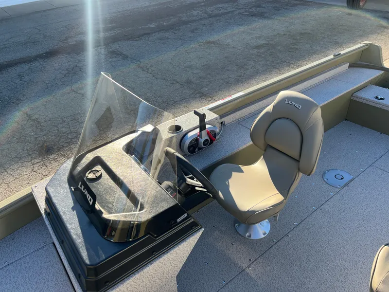 Slide: The Image of 2025 Lund 1875 Alaskan SS boat interior with steering console and seat. - 13