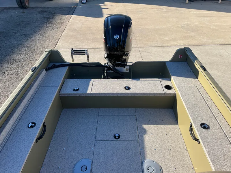 Slide: The Image of 2025 Lund 1875 Alaskan SS boat interior with motor, featuring spacious seating and storage. - 17