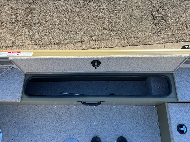 Slide: The Image of 2025 Lund 1875 Alaskan SS boat storage compartment, open and empty, with textured flooring. - 18
