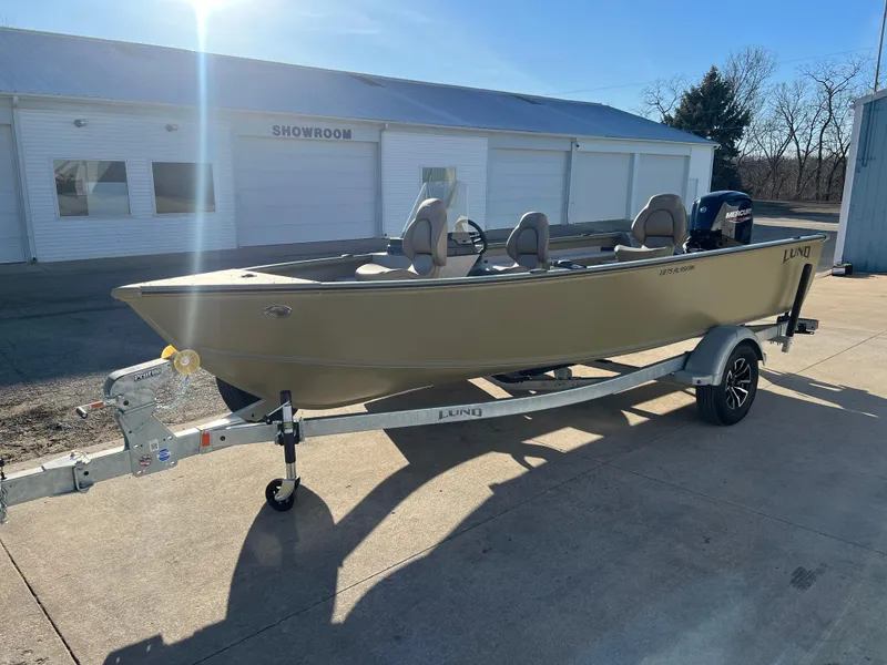 Slide: The Image of 2025 Lund 1875 Alaskan SS boat on trailer outside showroom. - 2