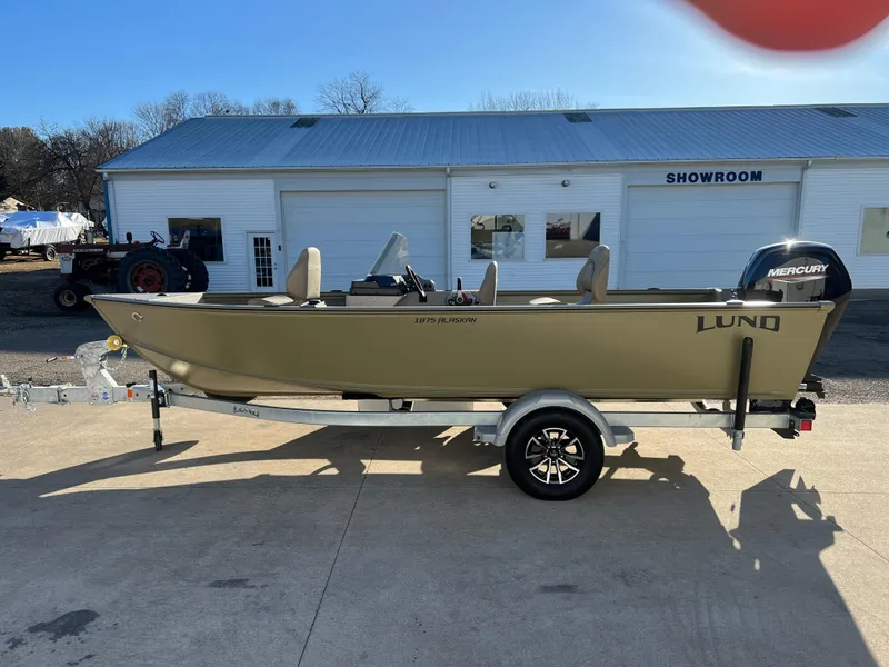 Slide: The Image of 2025 Lund 1875 Alaskan SS boat on trailer outside showroom. - 3