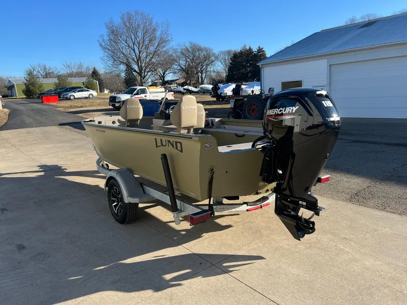 Slide: The Image of 2025 Lund 1875 Alaskan SS boat with Mercury engine on trailer, parked outdoors. - 4