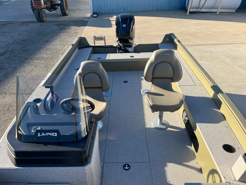 Slide: The Image of 2025 Lund 1875 Alaskan SS boat interior with two seats and steering console. - 7