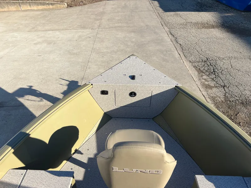 Slide: The Image of 2025 Lund 1875 Alaskan SS boat interior with seating and storage compartments. - 8