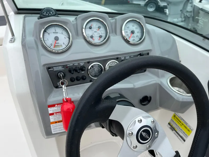 Slide: The Image of Dashboard of 2014 Chaparral 19 Sport H2O boat with steering wheel and gauges. - 10