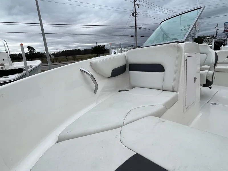 Slide: The Image of 2014 Chaparral 19 Sport H2O boat interior with white seating and windshield. - 16