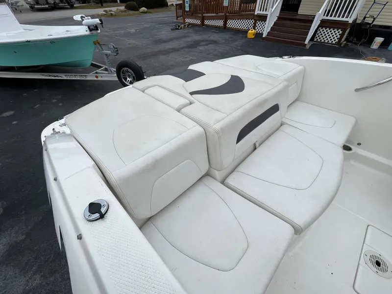 Slide: The Image of 2014 Chaparral 19 Sport H2O boat with white cushioned seating and sleek design. - 18