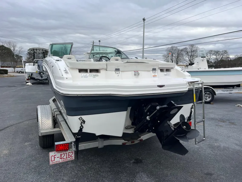 Slide: The Image of 2014 Chaparral 19 Sport H2O boat on trailer, rear view, overcast sky. - 6