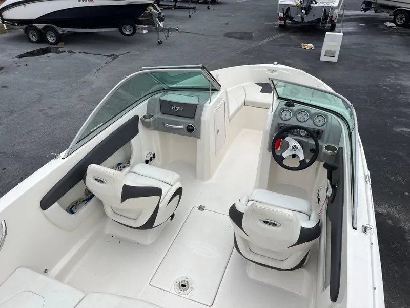 Slide: The Image of 2014 Chaparral 19 Sport H2O boat interior with steering wheel and seating. - 8